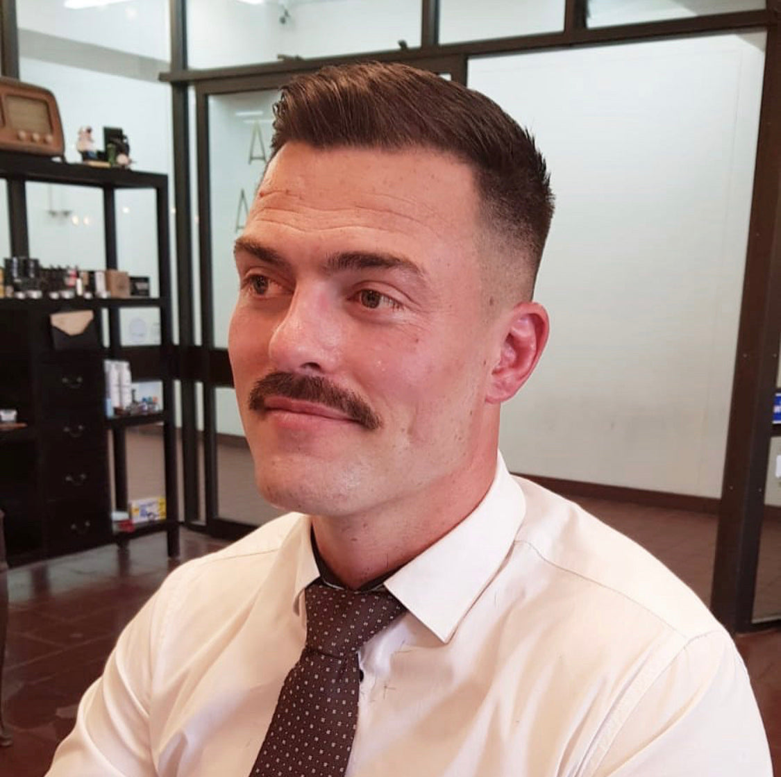 man with chevron moustache and big hair