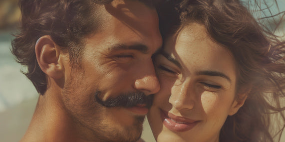 man with moustache after using milkman moustache wax beside girl friend at the beach