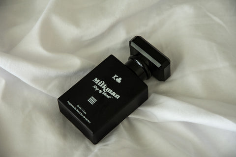 king of wood parfum for men hero image on white sheets
