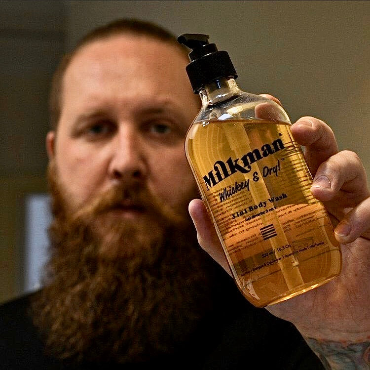 man holding milkman men's body wash