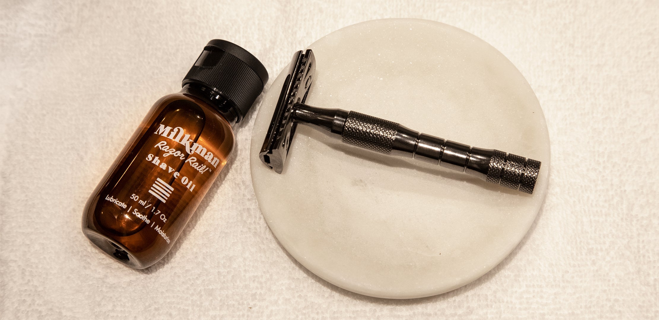 milkman shave oil and shave lubricant next to safety razor